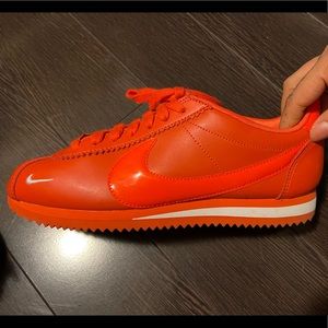 Woman’s Neon orange Nike Cortez shoes